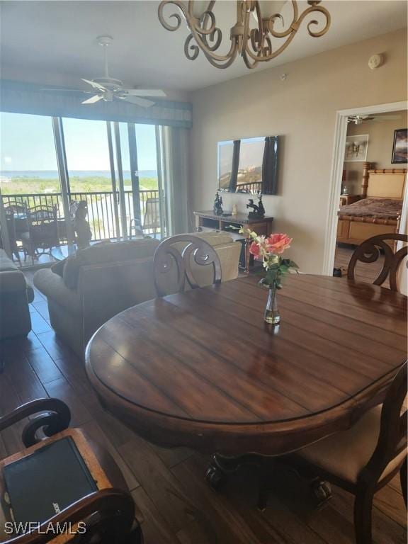 dining area with ceiling fan and dark hardwood / wood-style floors