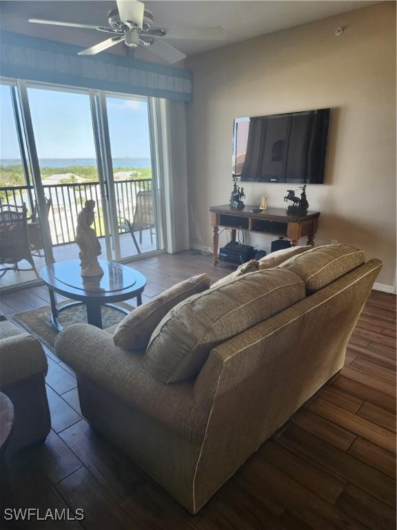 living room with ceiling fan and wood-type flooring