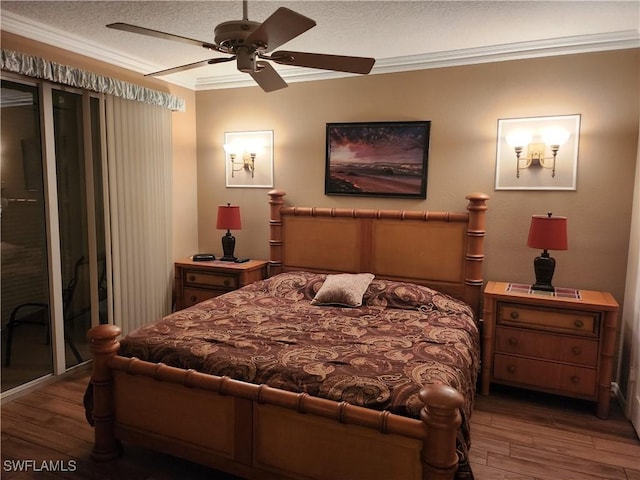 bedroom featuring wood-type flooring, ornamental molding, ceiling fan, and a textured ceiling