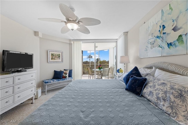 bedroom with ceiling fan, a wall of windows, access to exterior, and carpet flooring