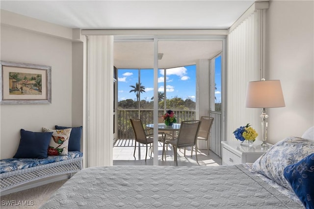 bedroom featuring expansive windows and access to outside