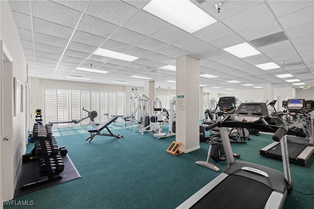 gym with a paneled ceiling