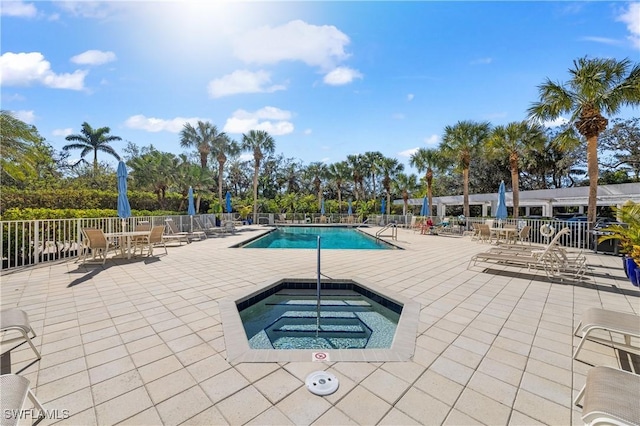 view of pool with a community hot tub and a patio