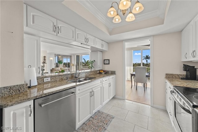 kitchen with white cabinetry, sink, a tray ceiling, and stainless steel appliances