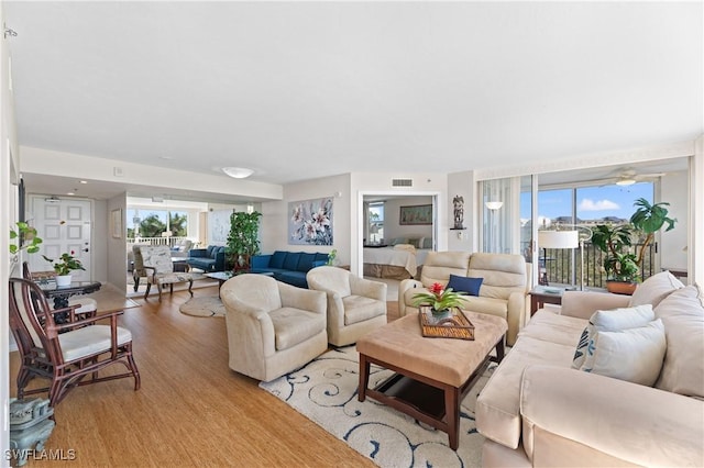 living room with plenty of natural light and light wood-type flooring