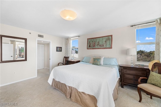 bedroom featuring light colored carpet