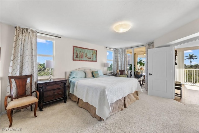 bedroom featuring access to outside and light carpet