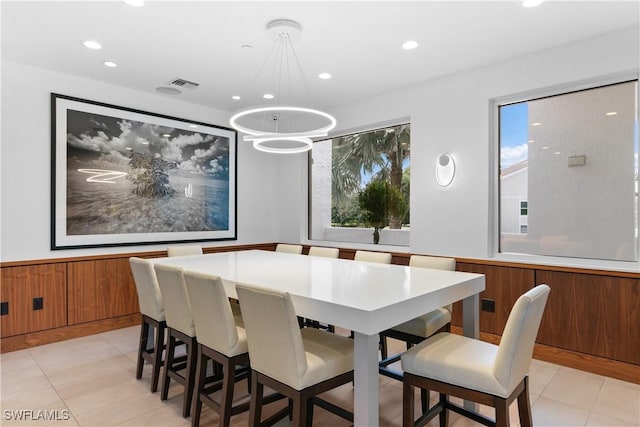 tiled dining space featuring plenty of natural light