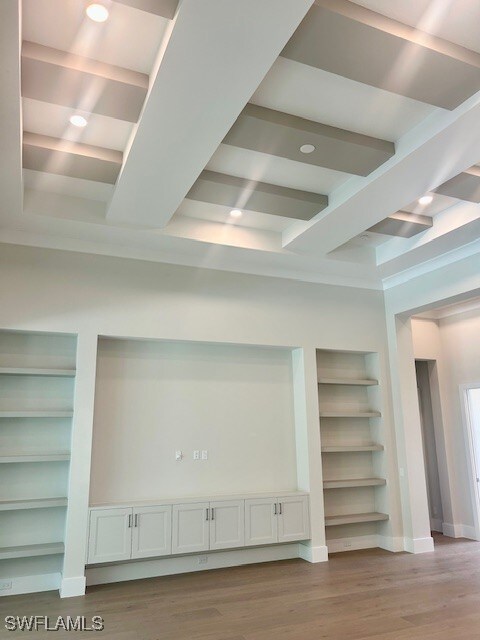9531 Caymas Way N, Naples, FL 34114 - detailed view of built in features, wood finished floors, beam ceiling, baseboards, and recessed lighting
