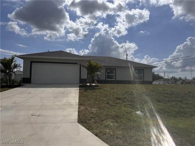 single story home with a garage and a front lawn