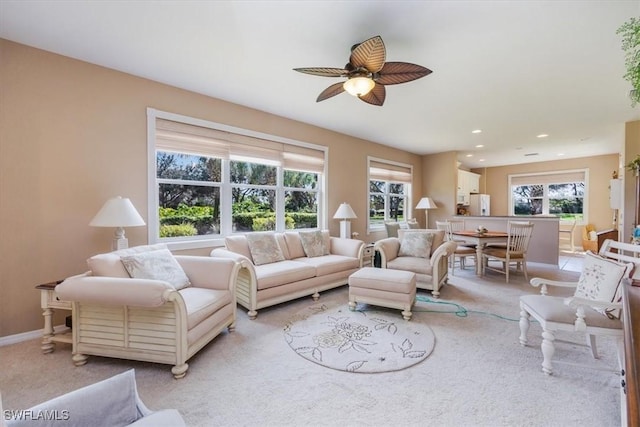 carpeted living room featuring ceiling fan