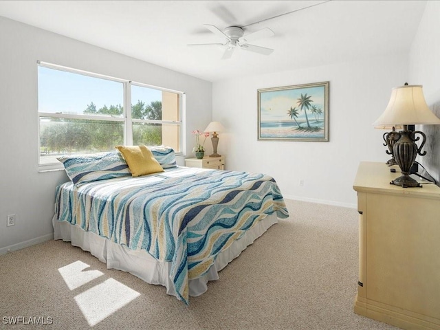 bedroom with ceiling fan and light carpet