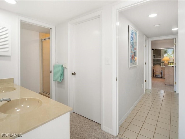 bathroom featuring vanity, tile patterned floors, and walk in shower