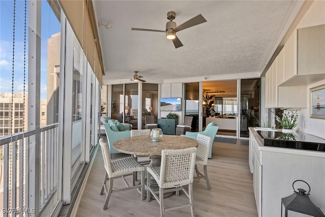 sunroom / solarium featuring ceiling fan