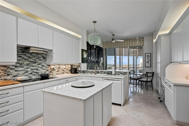 kitchen with sink, a center island, ventilation hood, hanging light fixtures, and dishwasher