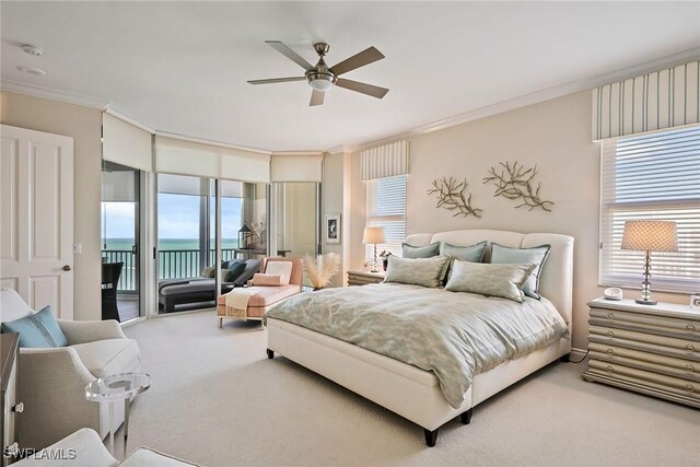 bedroom featuring a water view, ornamental molding, carpet flooring, and access to outside