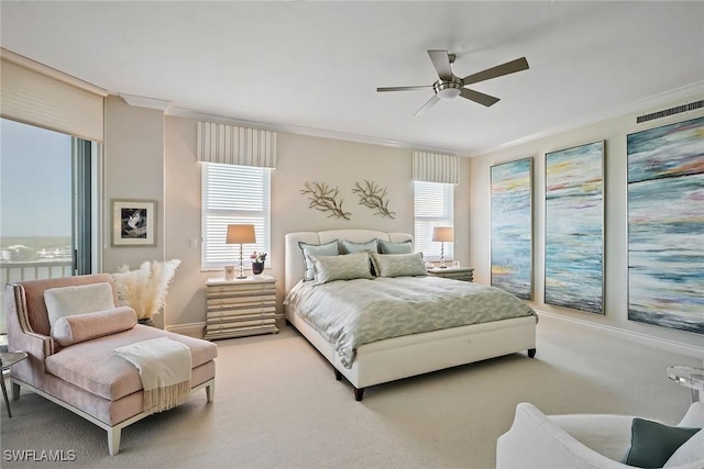 carpeted bedroom with multiple windows, crown molding, and ceiling fan