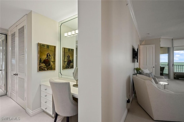 interior space featuring built in desk and ornamental molding