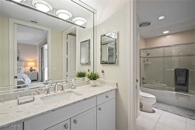 full bathroom with toilet, vanity, shower / bath combination with glass door, and tile patterned flooring