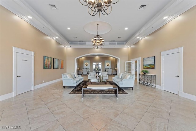 unfurnished living room featuring an inviting chandelier, a tray ceiling, and a high ceiling