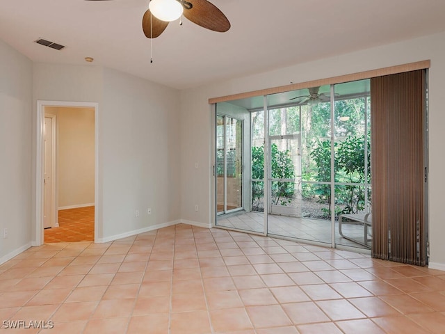 unfurnished room featuring ceiling fan, light tile patterned floors, and a wealth of natural light