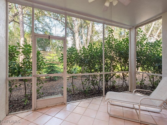 unfurnished sunroom with ceiling fan