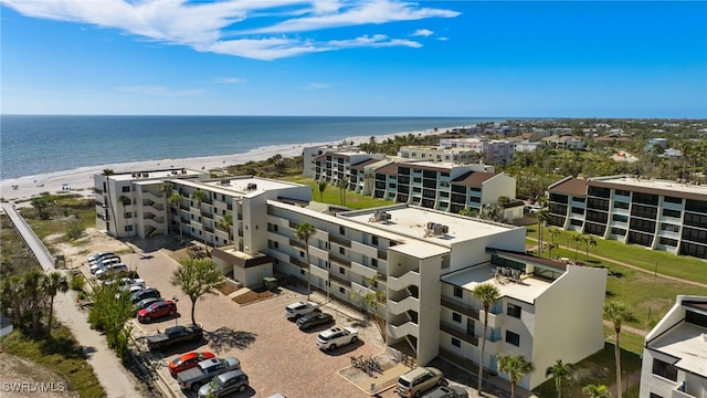 aerial view with a water view and a view of the beach