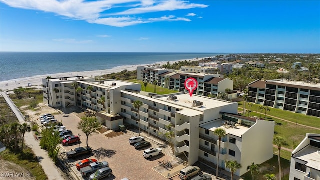 drone / aerial view with a water view and a view of the beach