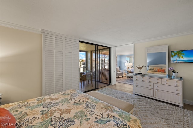 bedroom with crown molding, access to outside, light hardwood / wood-style floors, and a wall of windows