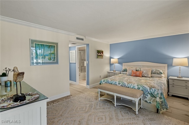 bedroom featuring crown molding, ensuite bathroom, and light hardwood / wood-style floors