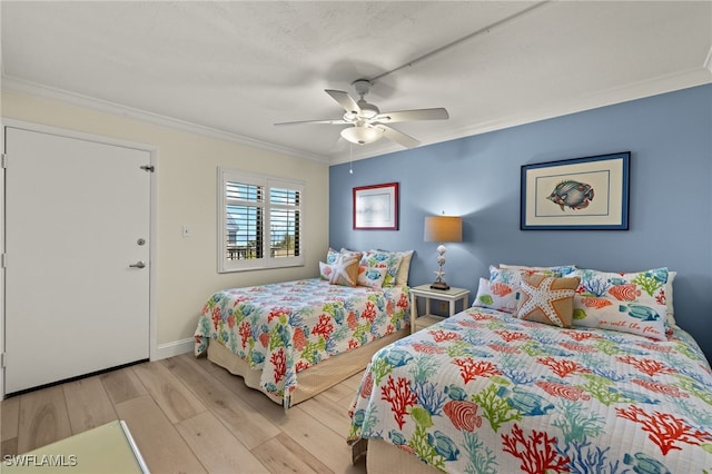 bedroom with ornamental molding, ceiling fan, and light wood-type flooring