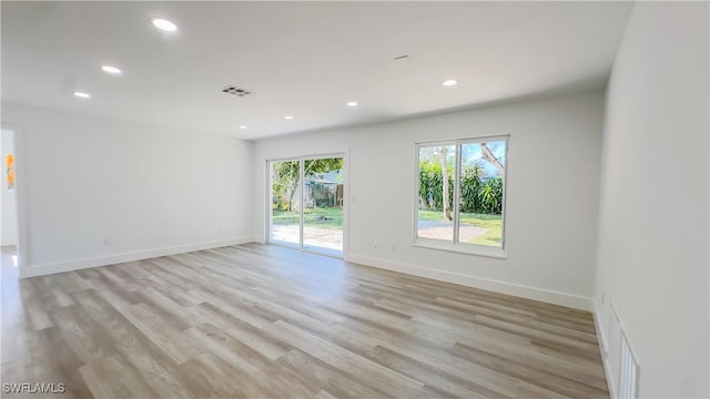 spare room with light hardwood / wood-style flooring