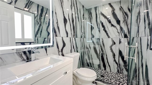 bathroom featuring vanity, a tile shower, tile walls, and toilet