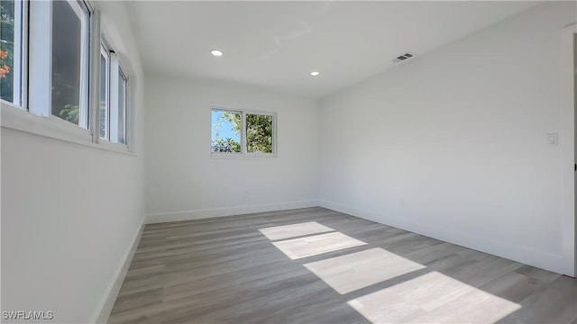 spare room with wood-type flooring