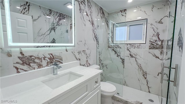 bathroom featuring vanity, a shower with door, tile walls, and toilet