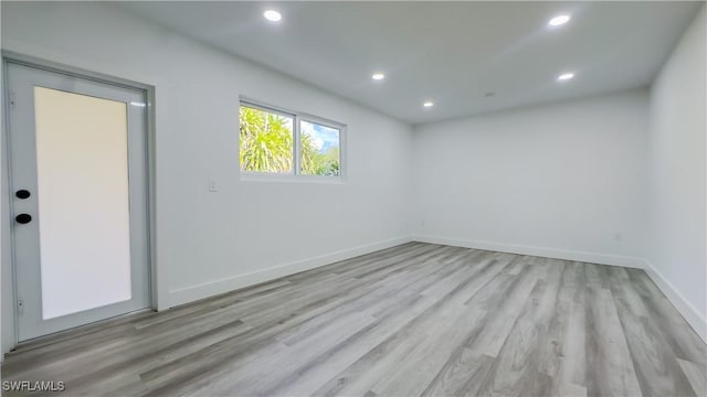 spare room with light hardwood / wood-style floors