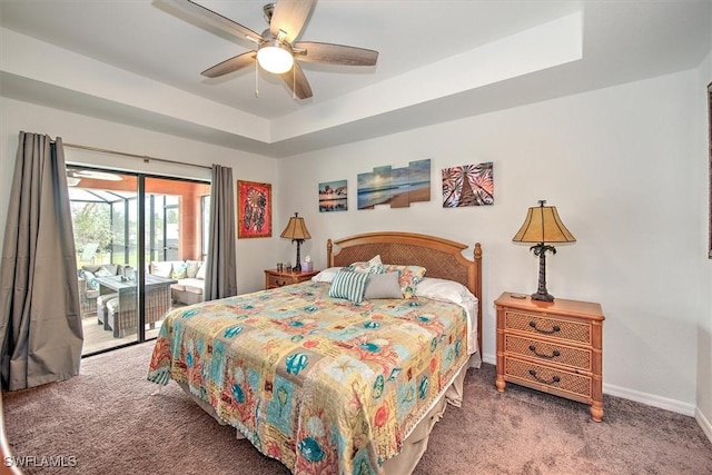 bedroom with ceiling fan, a tray ceiling, carpet floors, and access to outside