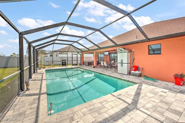 view of pool featuring a patio and glass enclosure