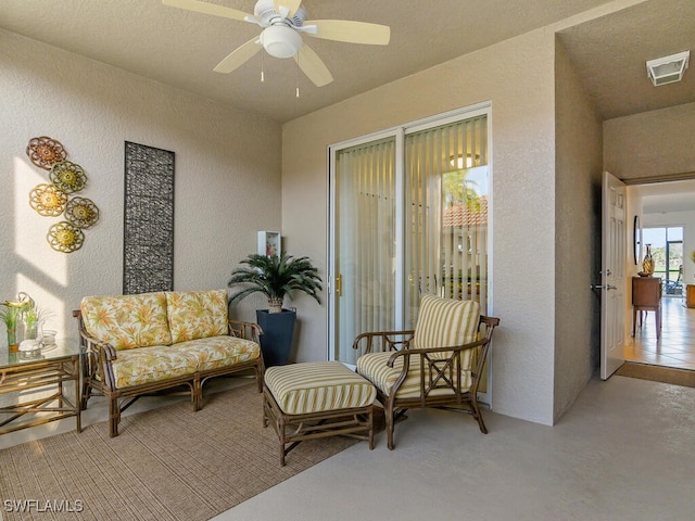 living area featuring ceiling fan