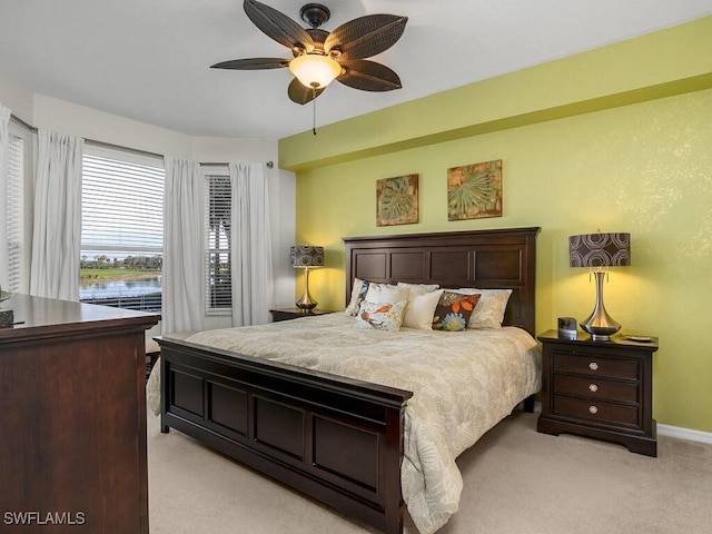 bedroom featuring light colored carpet and ceiling fan