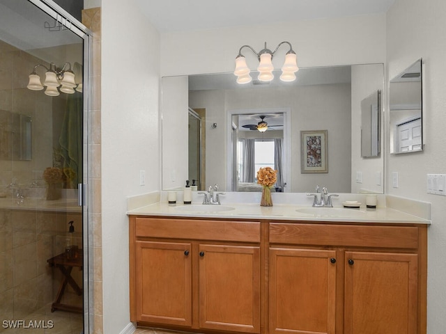 bathroom with vanity, an enclosed shower, and ceiling fan