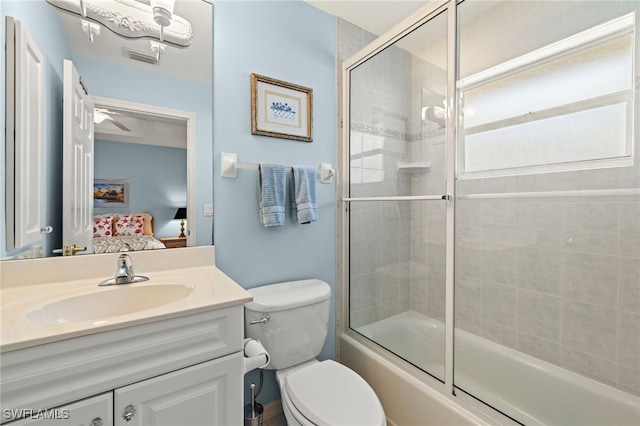 full bathroom with bath / shower combo with glass door, vanity, and toilet