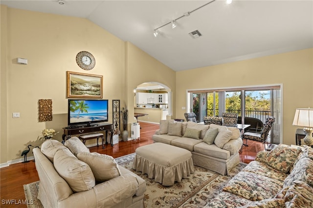 living room featuring track lighting, wood-type flooring, and high vaulted ceiling