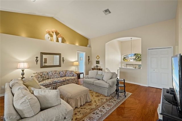 living room with high vaulted ceiling and dark hardwood / wood-style floors