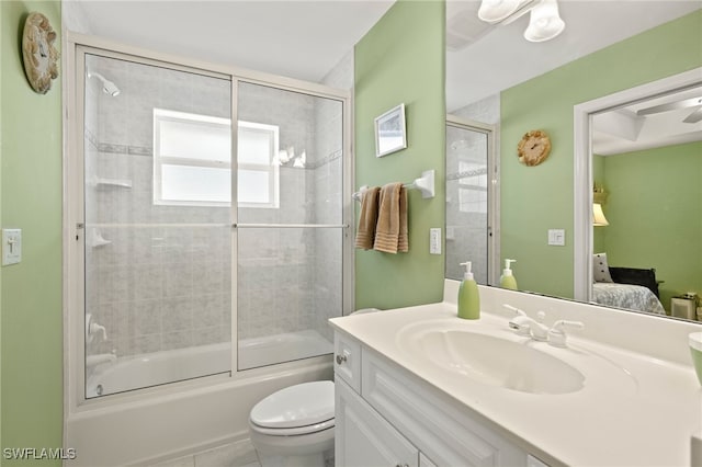 full bathroom with bath / shower combo with glass door, vanity, and toilet