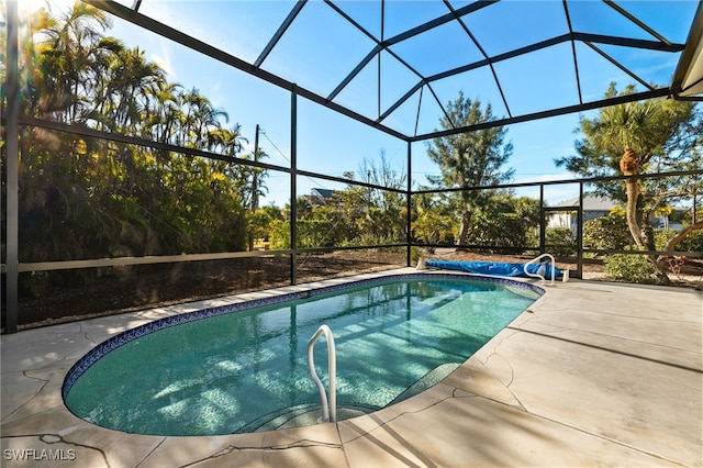 view of swimming pool with a patio area and glass enclosure