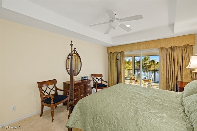 bedroom with ceiling fan, access to exterior, a raised ceiling, and carpet