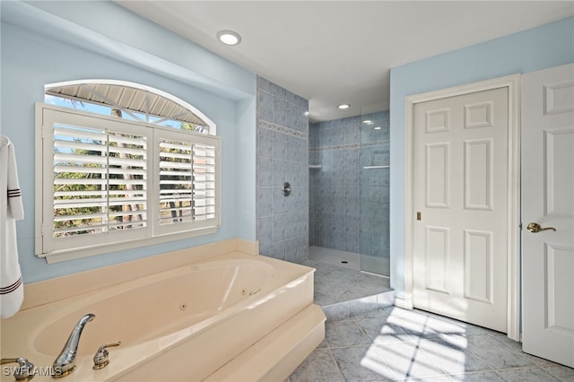 bathroom featuring plus walk in shower and tile patterned flooring