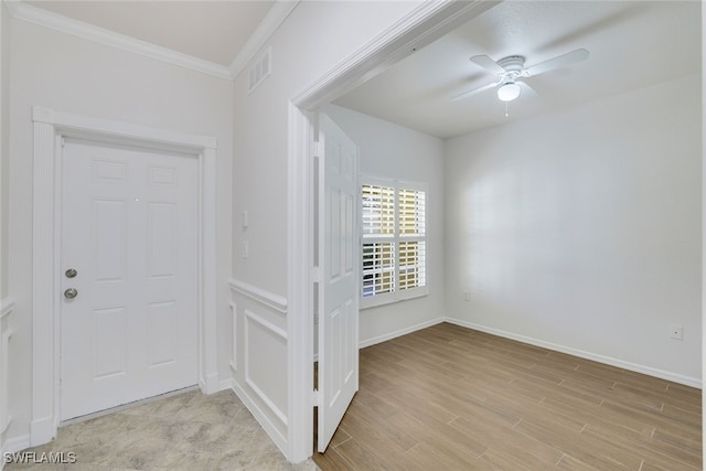 foyer entrance featuring crown molding, ceiling fan, and light hardwood / wood-style flooring