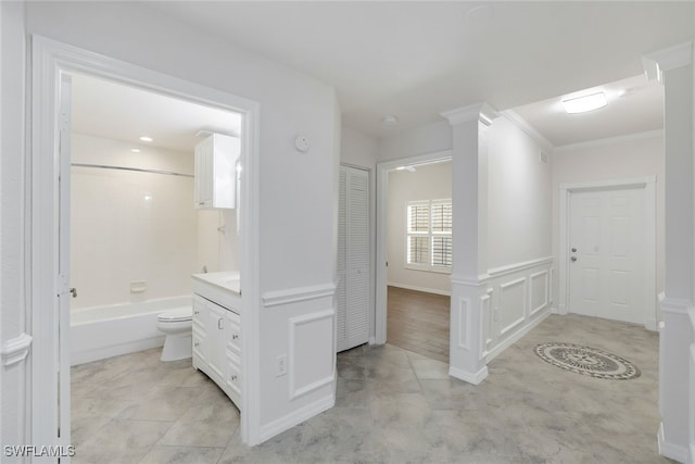 full bathroom featuring toilet, ornate columns, crown molding, shower / bathtub combination, and vanity